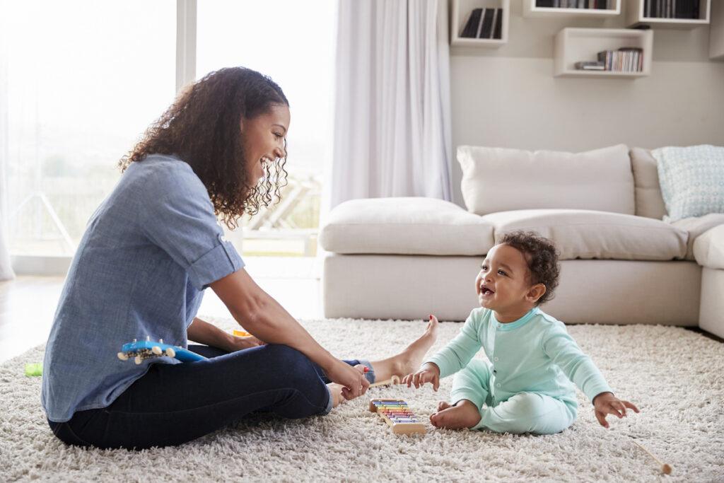 mother and toddler playing in living room